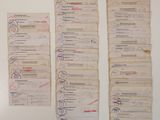 a lot of old papers that are on the wall