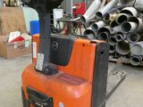 a forklift that is sitting in the middle of a warehouse