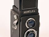 an old camera that is sitting on a white surface