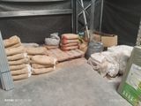 several bags of food are sitting on a table in a warehouse