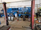 a picture of a garage with a lot of tools on the floor