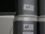 three speakers sitting on top of each other on a desk