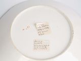a white plate with a piece of paper on it