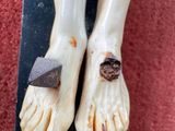 two feet that have been placed on a piece of wood