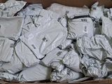 a cardboard box full of clothes that are sitting on the floor