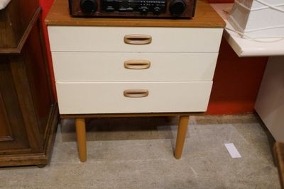 a microwave on top of a wooden cabinet in a room