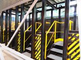 yellow and black stairs in a building with a yellow and black railing