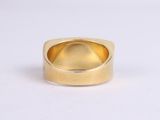 an image of a close up of a gold ring on a white surface