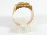 a close up of a gold ring on a white surface