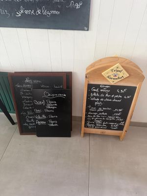 two chalk boards that are sitting next to each other