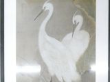 two birds that are standing on a branch in the water