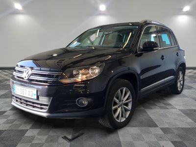 the volkswagen tiguan is parked in a garage with a checkered floor