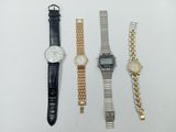 three watches are sitting next to each other on a white surface