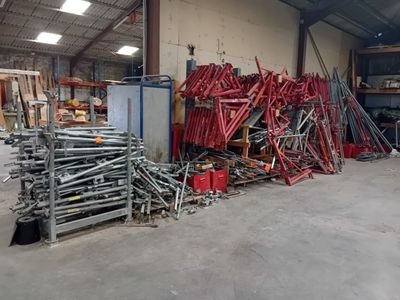 a large pile of metal and wood in a warehouse