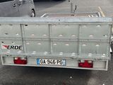a truck with a trailer attached to it in a parking lot