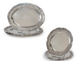 pair of silver plated dishes on stand on white background