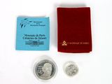 an image of a silver coin with a red pouch next to it