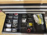 a tool drawer that has many items in it