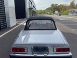 an image of a silver convertible car parked in a parking lot