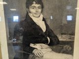 a black and white photo of a man sitting in a chair