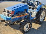 a blue tractor that is parked in a parking lot
