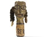 wooden head of a person with a sign on it that says area