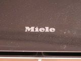 a close up of a laptop with the name miele written on it