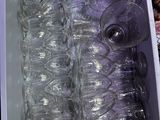 many empty wine glasses in a plastic container