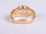 an image of a close up of a gold ring with a heart on it