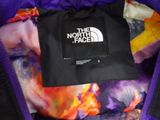 the north face purple and black jacket with the north face logo on it
