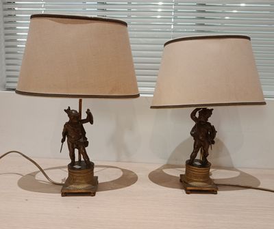 two lamps that are on a table with a lamp on it