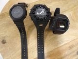 three watches sitting on a wooden table next to each other