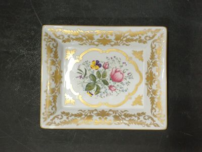une petite assiette décorée de fleurs, posée sur une table