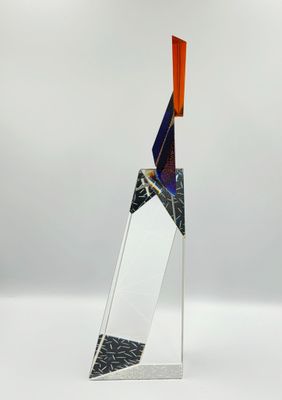 a glass sculpture of a sailboat on a white surface