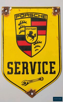 a yellow porsche service sign hanging on a white wall