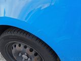 a close up of a car ' s tire on the side of the road