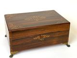 a small wooden box with a decorative design on it