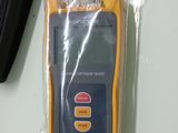 a yellow and black electronic device sitting on a table