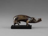a bronze figurine of a pig on a black base