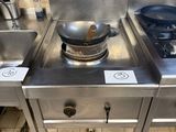 three stainless steel sinks in a kitchen with a stove top