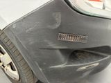 a close up of a car ' s front bumper with scratches on it