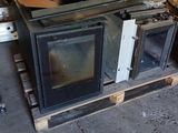 a stove sitting on top of a pallet in a garage