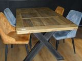 a wooden table with four chairs around it in a room