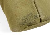 a close up of a tan bag with a tag on it