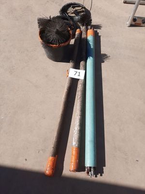 two baseball bats and a ball on the ground