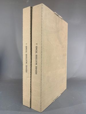 two books are stacked on top of each other on a table