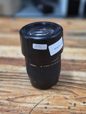 a close up of a camera lens sitting on a wooden table