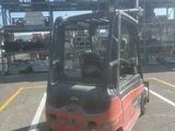 a red fork truck that is parked in a parking lot