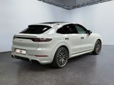 the rear of a white porsche cayense parked in a showroom
