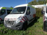 several ambulances parked in a grassy field with trees in the background
